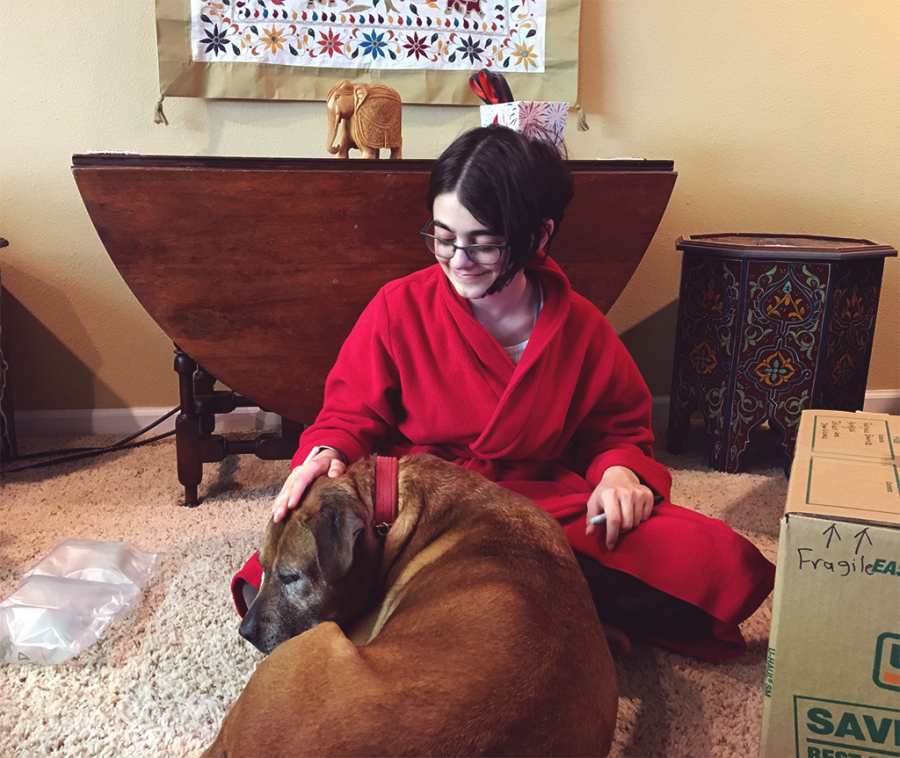 Junior Savita Yopp pets her dog, Lily. “Lily is such a lemon. Anything and everything will make her sick. It is ridiculous. I totally love her though,” Yopp says.