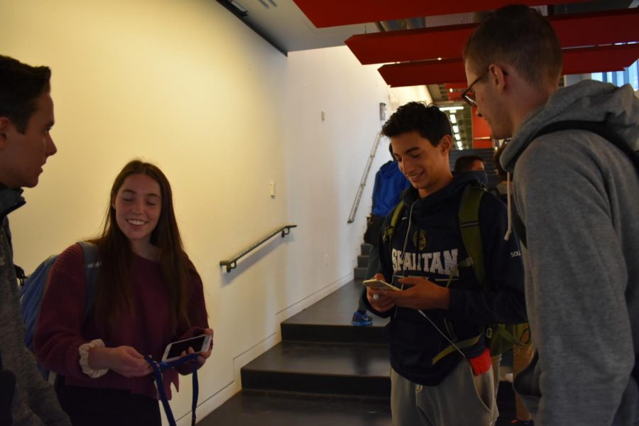 CONNECTION. Seniors Henry Hallaway and Claire Hallaway converse with junior Max Soll and senior Zachary Tipler.