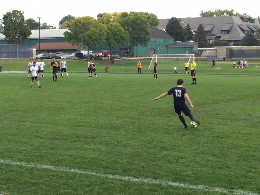 Sophomore Jackson Biggs sends the ball towards the opponents goal on a free kick. 