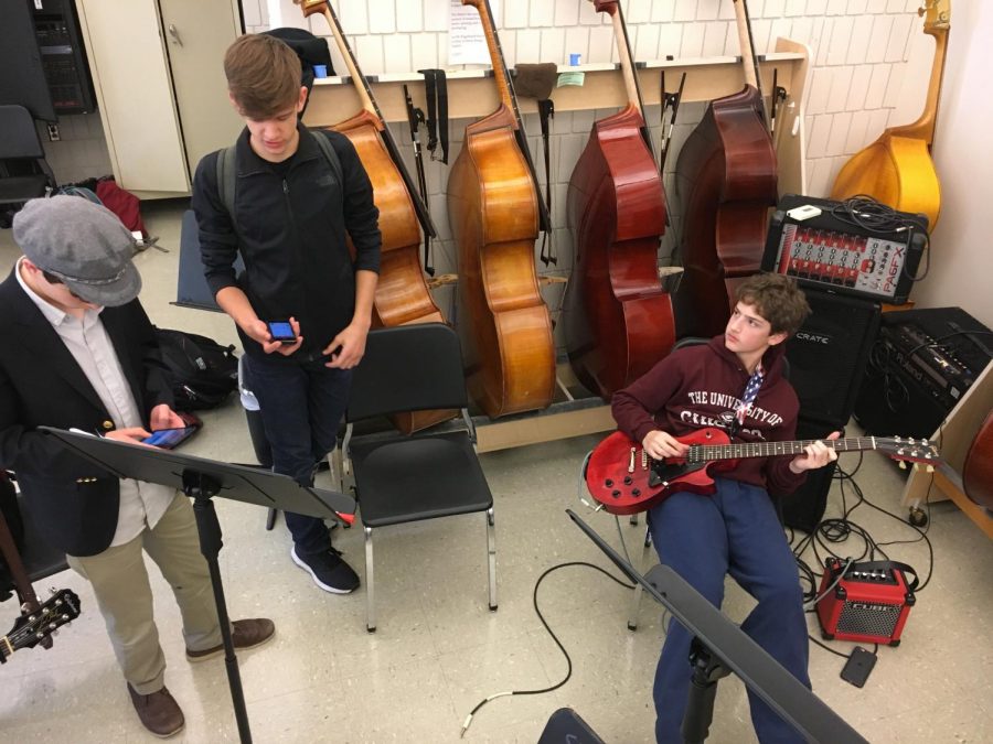 Ninth+graders+Henry+Burkhardt+and+Nathan+Mann%2C+and+sophomore+Sam+Konstan+warm+up+before+their+band+practices.