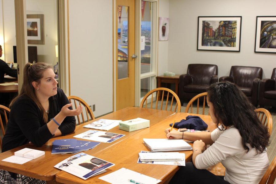 Assistant Director of Admissions at Whitman College Madison Hollenbeck talks to senior Elea Besse at a college visit. “A visit really helps pull back the curtain,” Hollenbeck said.