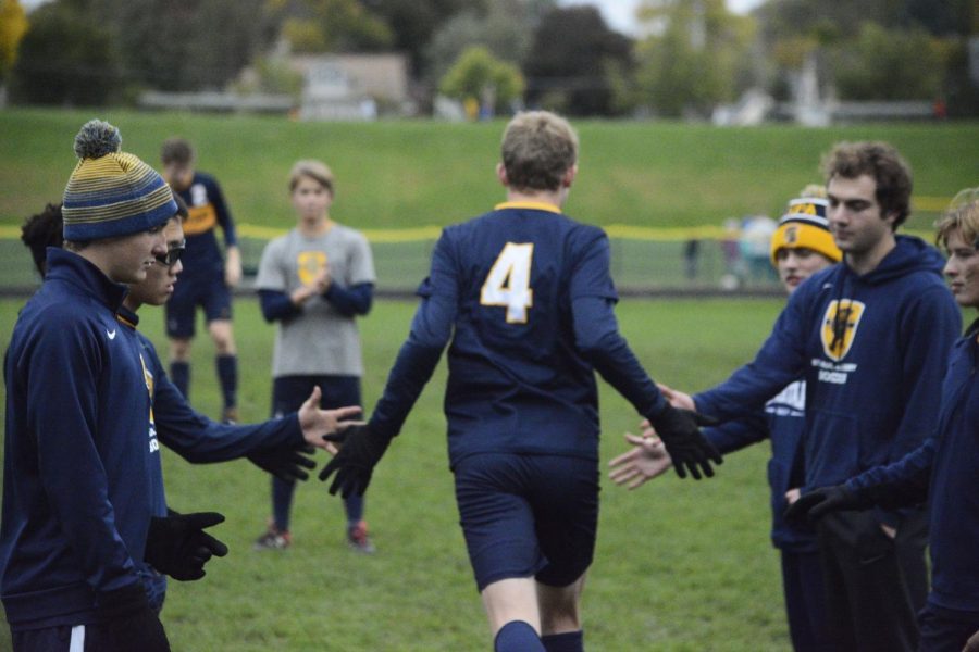 Senior Ben Carlsson runs onto the field as he is being announced.