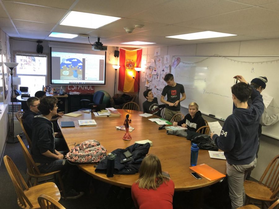 Students write on the board during a Spanish class as a way to keep them engaged.