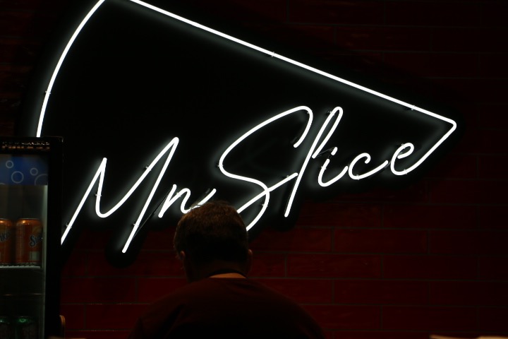 The sign at MN Slice, a pizza slice shop that serves unique square-square shaped pizza slices. 