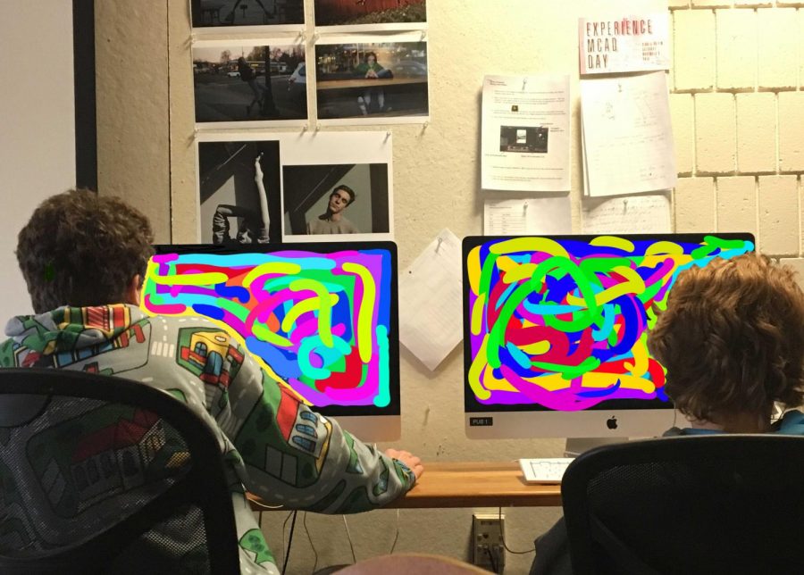 Two students edit videos in the Advanced Video Arts class.