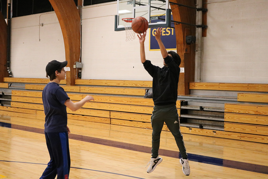 PLAY members shoot baskets in the gym.