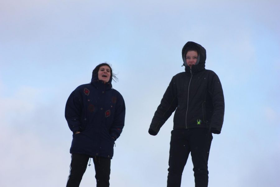 Seniors Jenny Sogin and Bailey Donovan watch their teammates. "My favorite part of the game was when my team got the first of the two Nordic flags because people really underestimate the alpine team," Donovan said. 