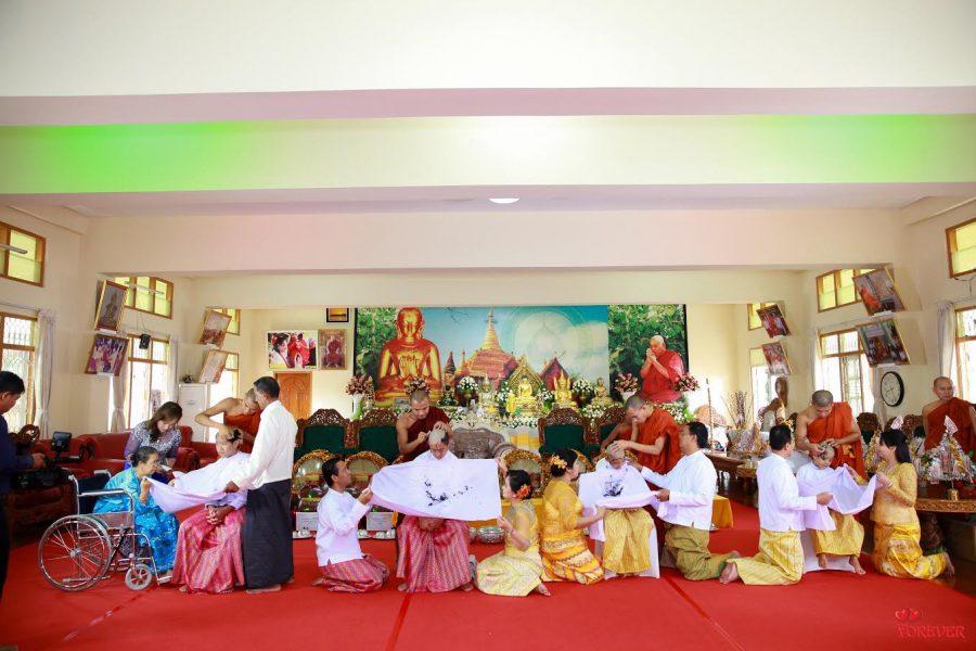 Justin Hla and his brother have their heads shaved by Buddhist monks.