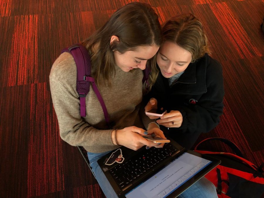 Senior Muriel Lang shows senior Janie Brunell Instagram's new secret story feature. 
