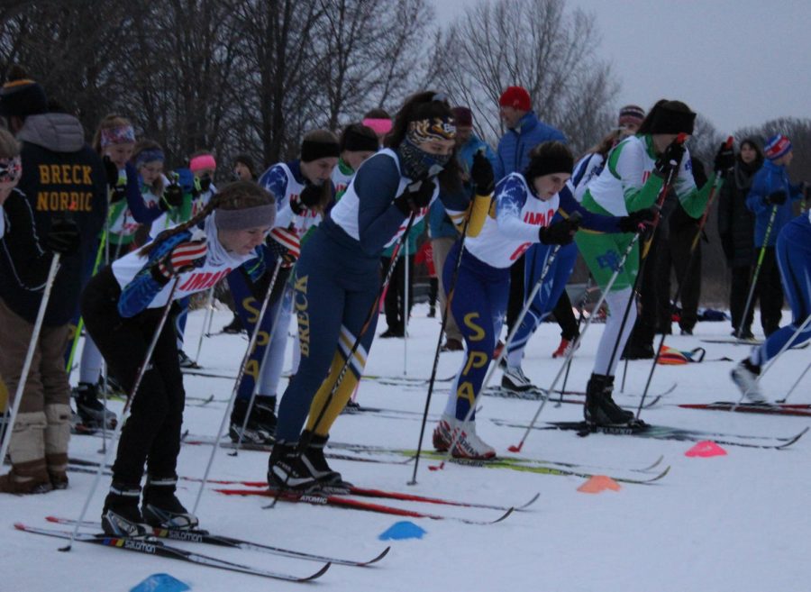 Skiers line up, ready to go