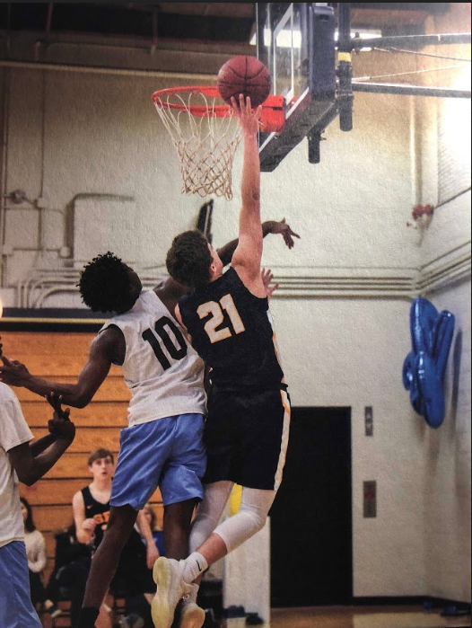 Senior Will Christakos rises to get a rebound.