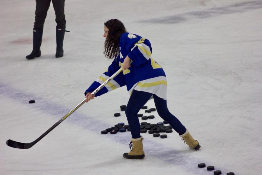 US Fitness teacher Cari Jo Anderson shoots the puck in the teacher shooting challenge on Jan. 22. 