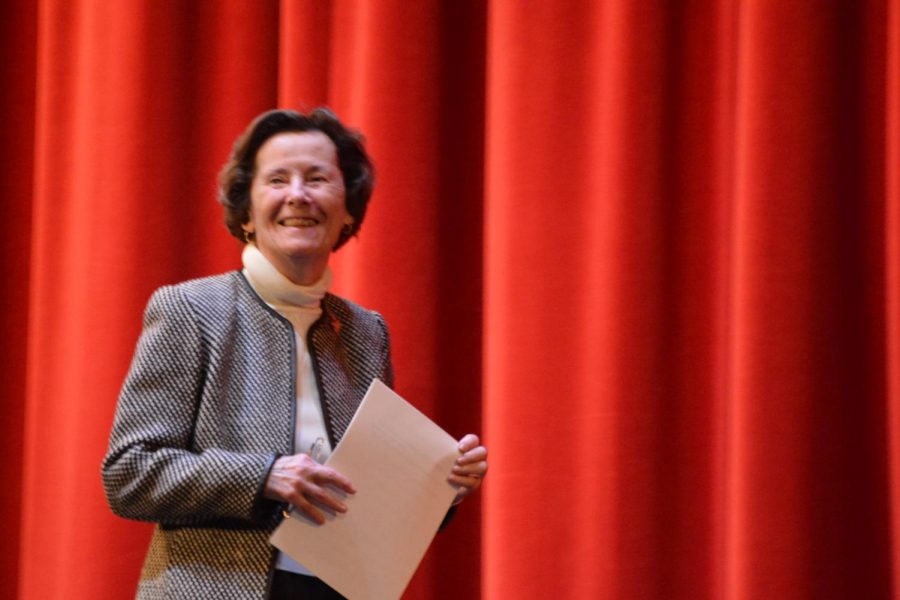 Ruth Huss 57 listens to applause from students and faculty before her speech to the school. “Im standing here today in this beautiful facility and am thankful to this very school which helped me form the foundation of my life,” Huss said.