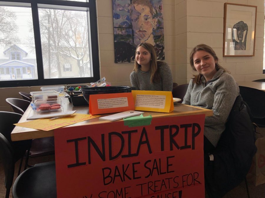 Senior Gabby Harmoning and sophomore Maxanne Millerhaller sell baked goods to the SPA community during lunch.