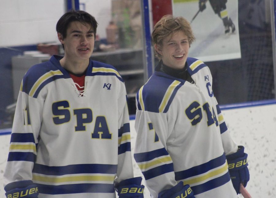 Seniors John Lynn and Adam Zukowski smile before the game starts.