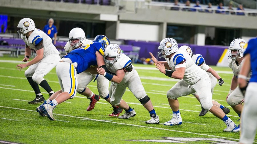 Senior Riley Tietel blocks a member of the opposing defensive line.