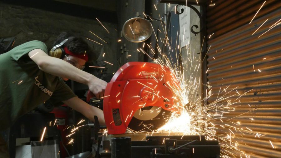 Senior Ben Atmore cuts the steel with a machine that produces sparks. "I really like the permanence of metalworking and use this very strong material to create whatever your heart desires," he said. 