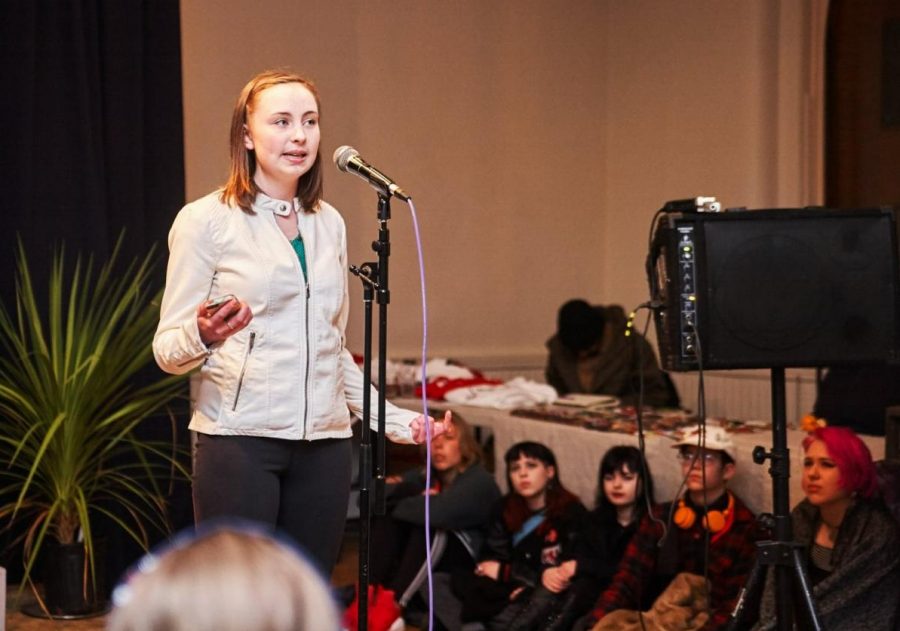 Junior Anna Snider performs a poem of hers at a slam.