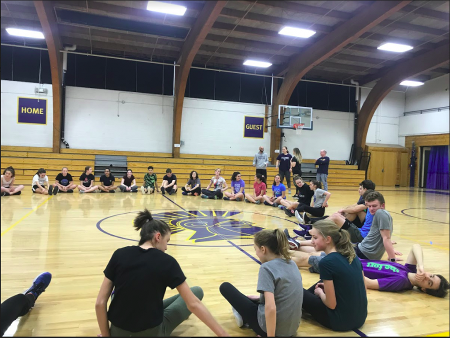 The track team practices inside the gym while they still arent able to get outside.