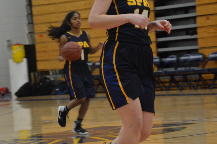 Sophomore #1 Rashmi Raveendran takes the ball up-court.