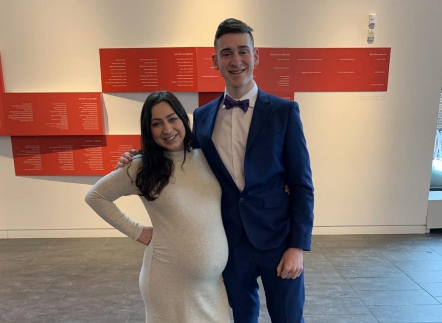 Reuben Vizelman and his sister pose in the Huss Center after his senior speech.