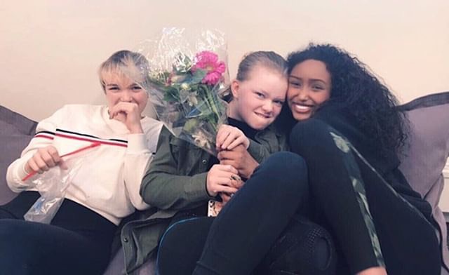 Sophomore Adrienne Gaylord and ninth graders Maura Hartfeldt and Nafisa Hagi-Aaden hang out at the IWD party.