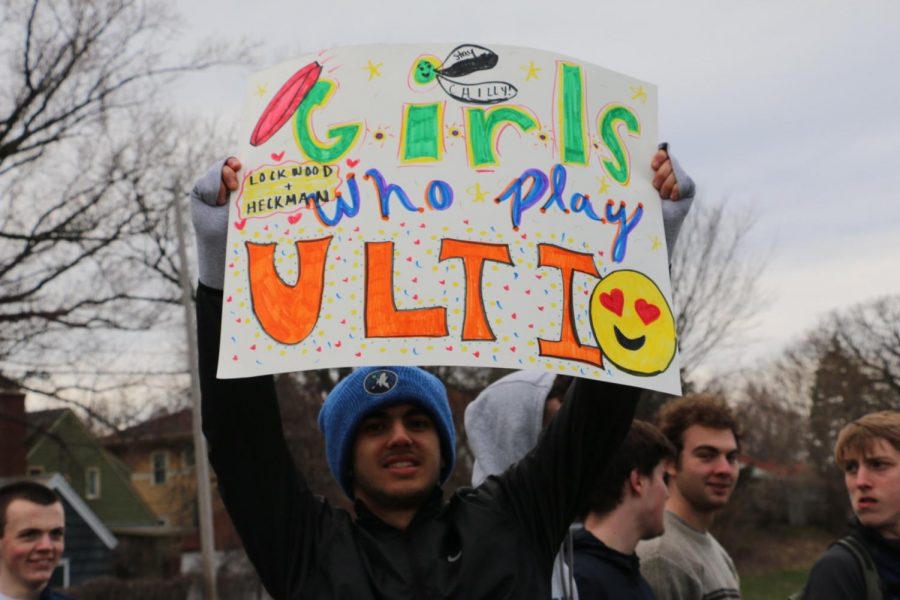 Senior Ethan Less holds up a sign to support the Girls Ultimate Team. 