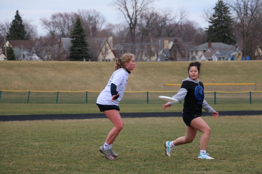 Senior and captain Elea Besse throws the frisbee to a teammate against Cretin. 