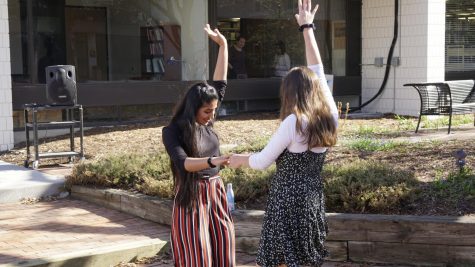 Seniors Mashal Naqvi and Isabel Saavedra-Weis enjoy the warm weather and energizing music.