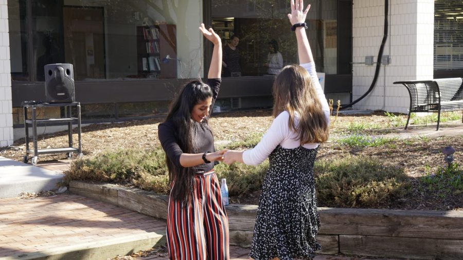 Seniors Mashal Naqvi and Isabel Saavedra-Weis enjoy the warm weather and energizing music. 