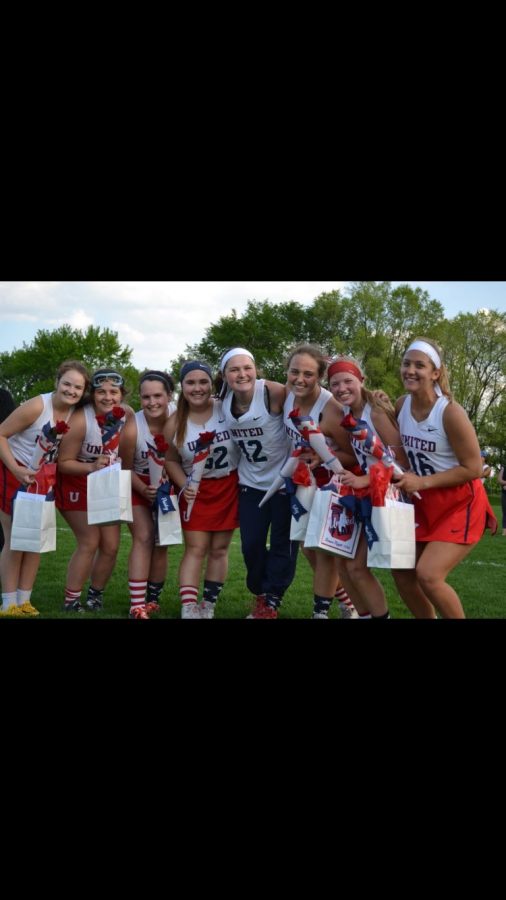 Giese #22) stands with members of United Lacrosse at the end of last season.