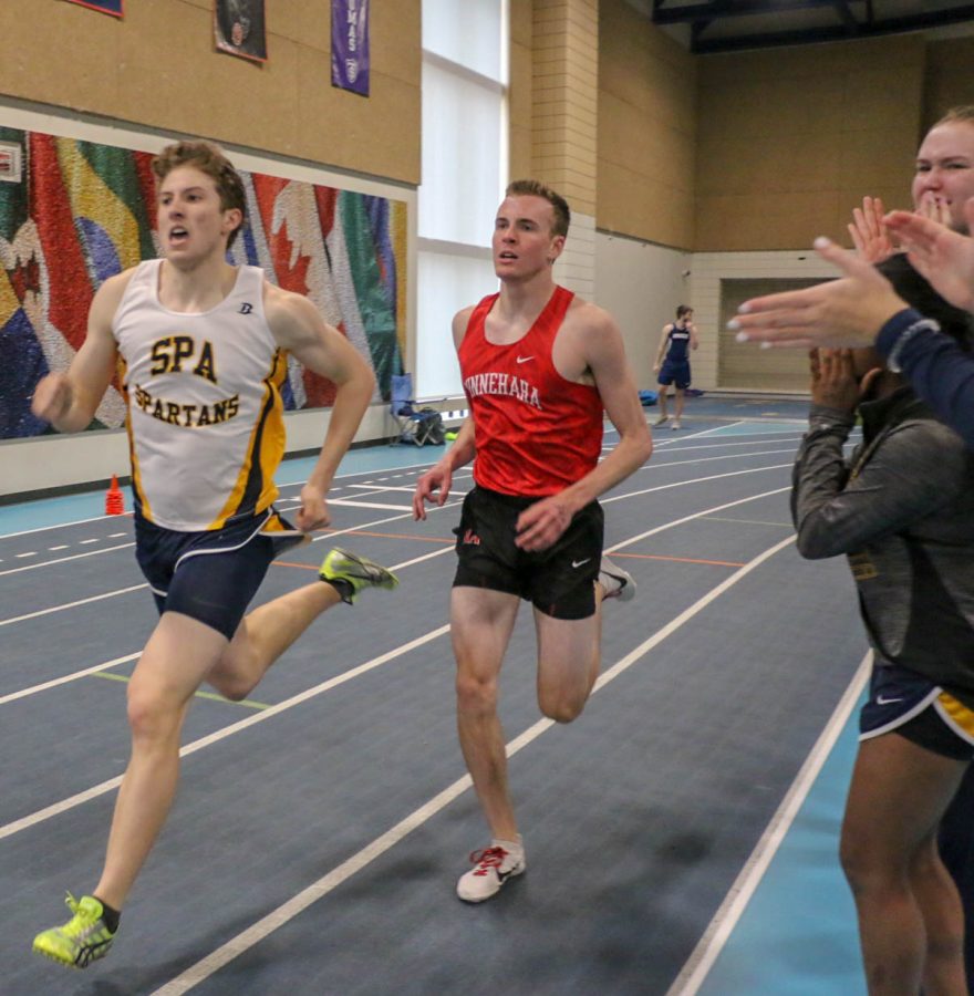 Junior Tommy Allen surges past an opponent as onlookers clap.