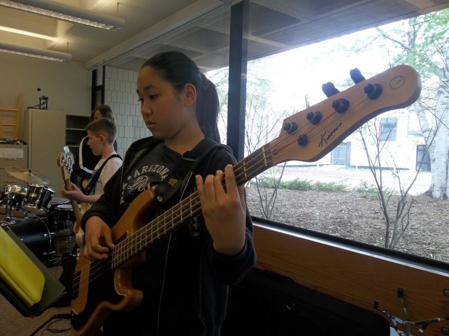 Sophia Bietz is practicing her bass guitar before class starts.