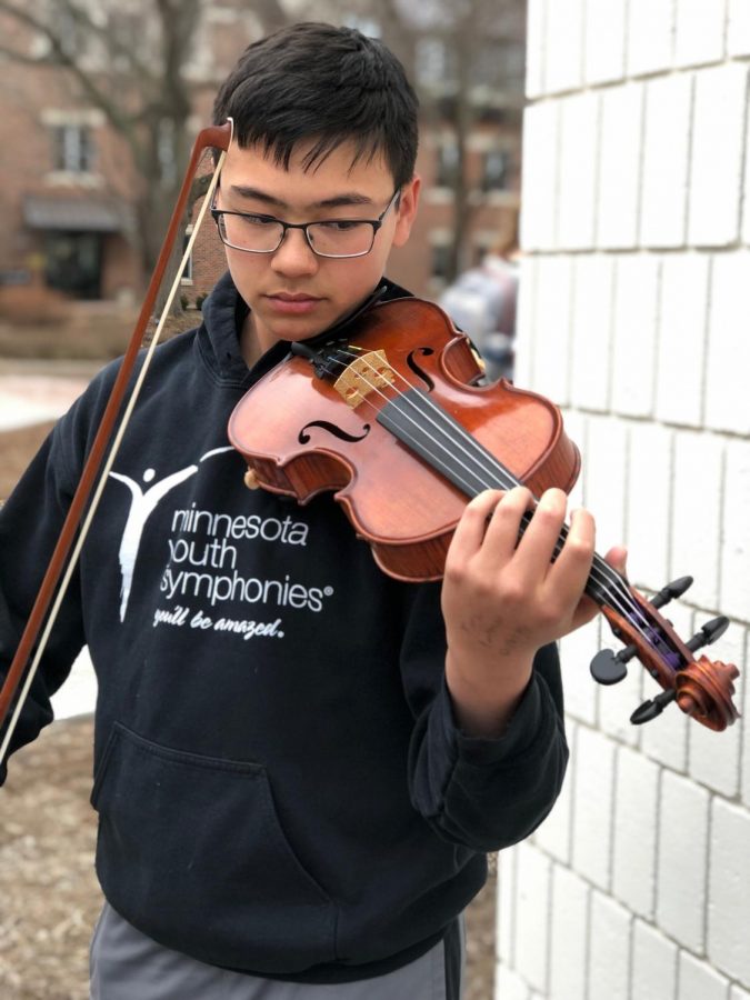 9th grader Kai Sih spends hours with his violin playing with a traveling orchestra in addition to SPA's orchestra.