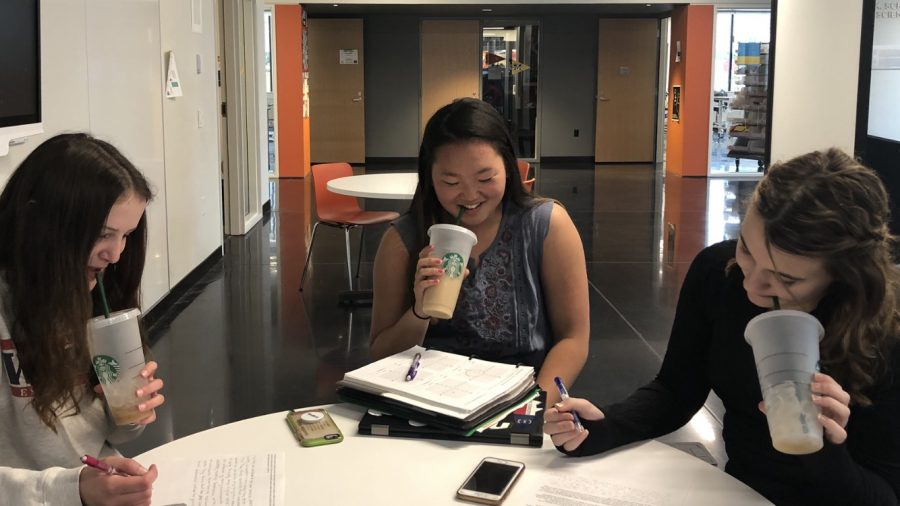 Sophomores Eloise Duncan, Jasmine White, and Maxanne Millerhaller take a sip of coffee from their starbucks cups.