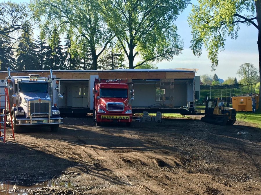 The small vehicle removing the portables slipped in the mud, so workers weighed it down with bricks.