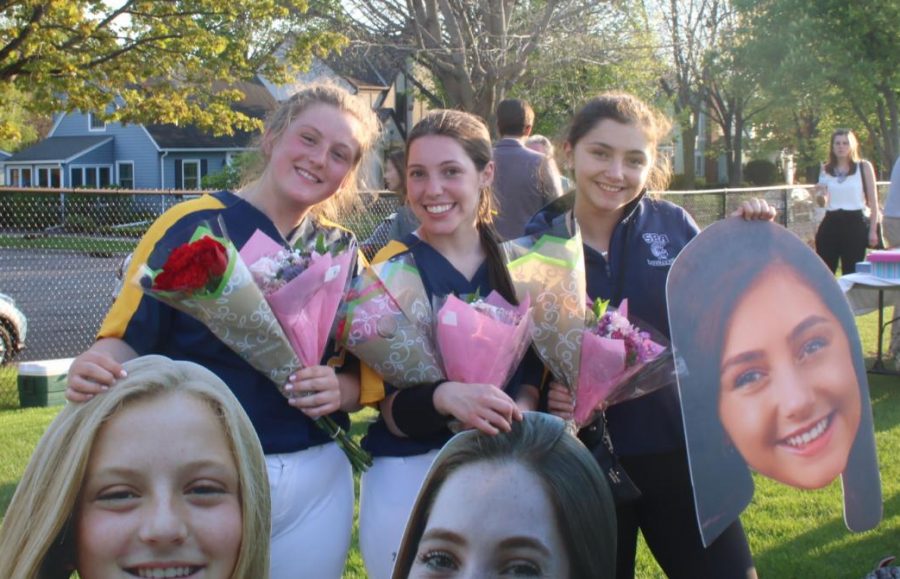 Seniors Ellie Nowakowsi, Claire Hallaway and Mia Litman pose with their cutouts. 