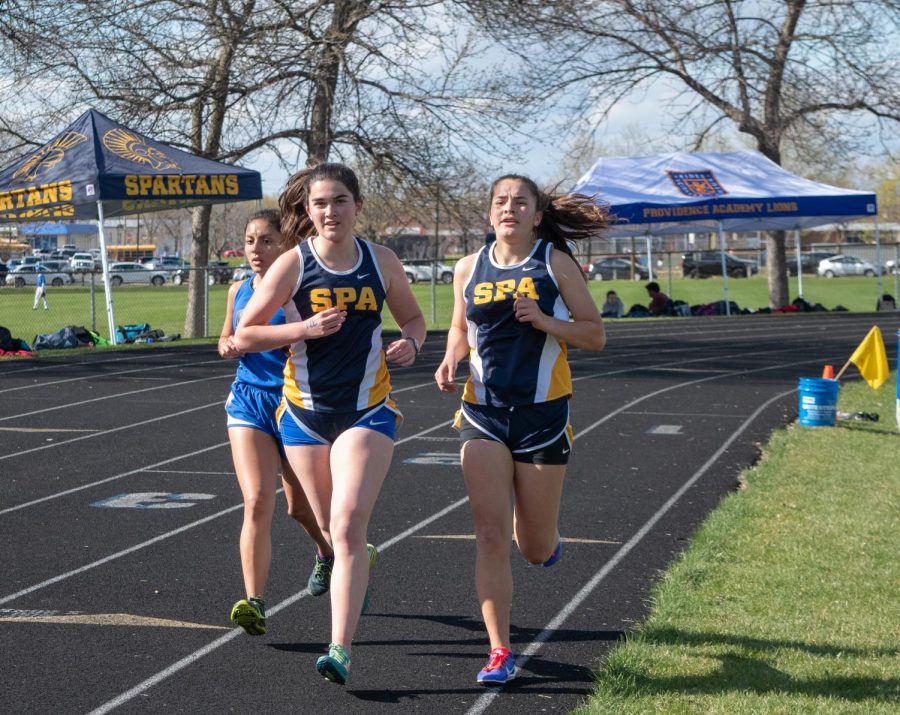 Senior Eliza Reedy and sophomore Isabel Isabel Toghramadjian halfway through their 1600m race. 