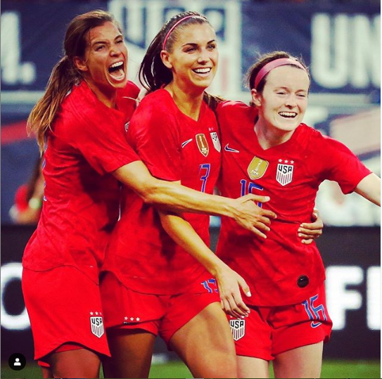 U.S. national players Tobin Heath, Alex Morgan and Rose Lavell celebrate a goal.