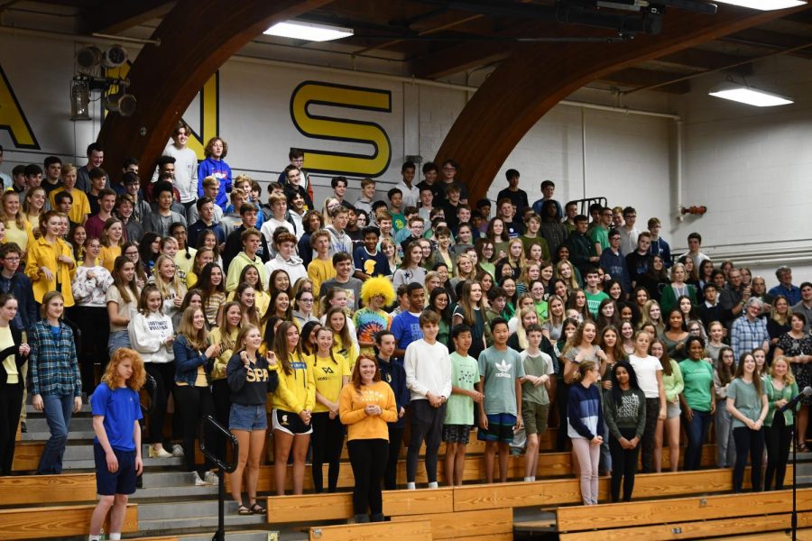 Sophomores, wearing yellow and 9th graders, wearing green, learn and perform the Spartan Beat at the end of the assembly to kick off the homecoming week. 