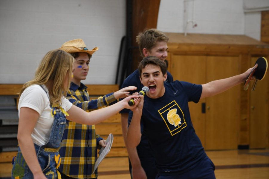 Junior Luka Shaker-Check yells into the microphone after he and his partner, junior Liam Lynch, won the ping-pong championship.