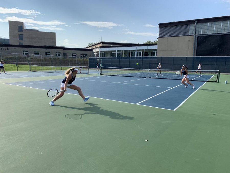 One of the four doubles 
matches last night. The Girls Varsity Tennis team currently holds a record of 5-3.