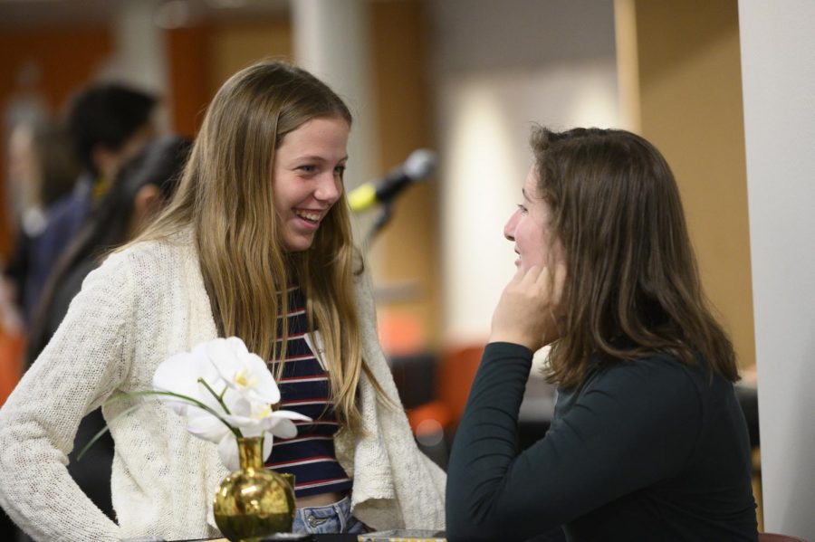 Sophomore Clara Garner and junior Isabelle Wolpert talk at the Grand Opening.