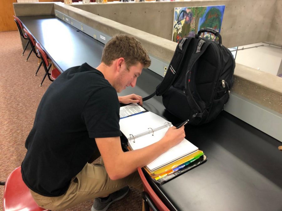 Senior Tommy Allen studies and does homework in the upper library. It all probably took me about 39 and a half hours a week, sometimes overtime. In actuality, it’s just like regular school… it changes week to week based on whatever assignments you get, Allen said.