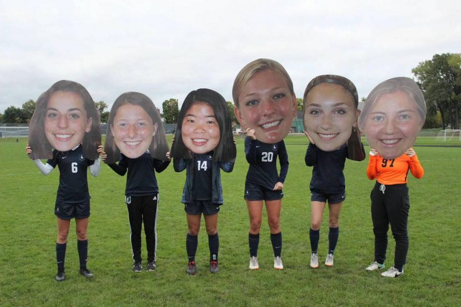 Seniors posed for a post-game picture with their cutouts, a team tradition.