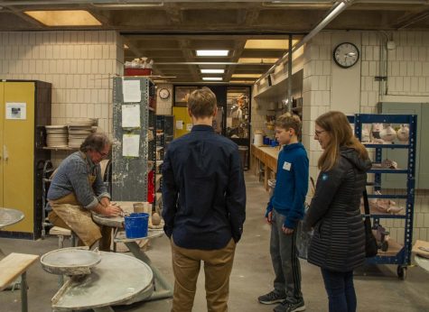 Ceramics teacher Daryn Lowman shows potential students an example of what art students can expect in his class.