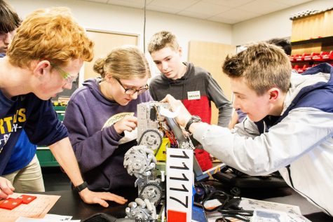 Juniors Michael Moran, Miranda Bance, and John Hall work on their robot. On Wednesday, the team had their first meet of the year, which also happened to be the first meet SPA has ever hosted. "Previously the meets sometimes would be like an hour away in North Branch, and it’s nice to have it here. It’s a little stressful. It’s like hosting a party at your house. You have to make sure there’s enough food for everyone, everything is cleaned up and ready to go," Design and Innovation Specialist Kirsten Hoogenakker said. 