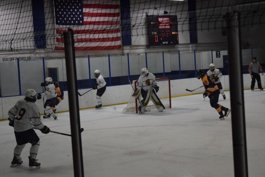 Senior Goalie Tom Kuriscak remains alert in the net while Junior Will Schavee battles at Mahtomedi player. 