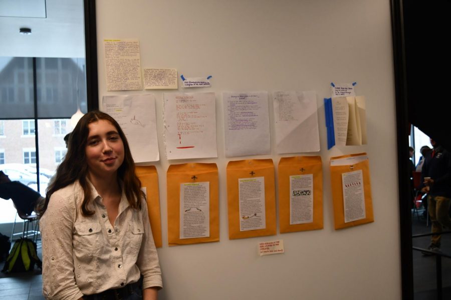 Junior Addie Morrisette pictured with her friendship-focused poetry project. The poems are copied in her friends' handwriting. 