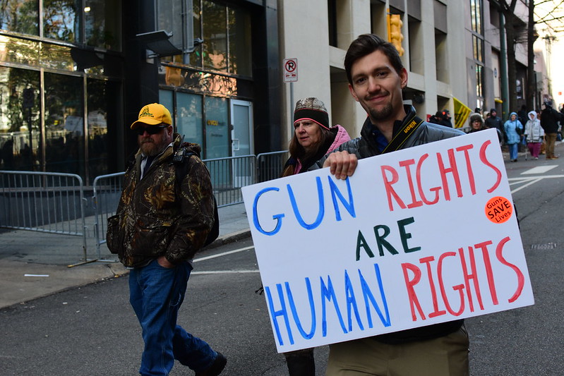 An attendee of the Virginia Second Amendment Rally exercises two rights guaranteed by the Constitution: gun ownership and free speech.